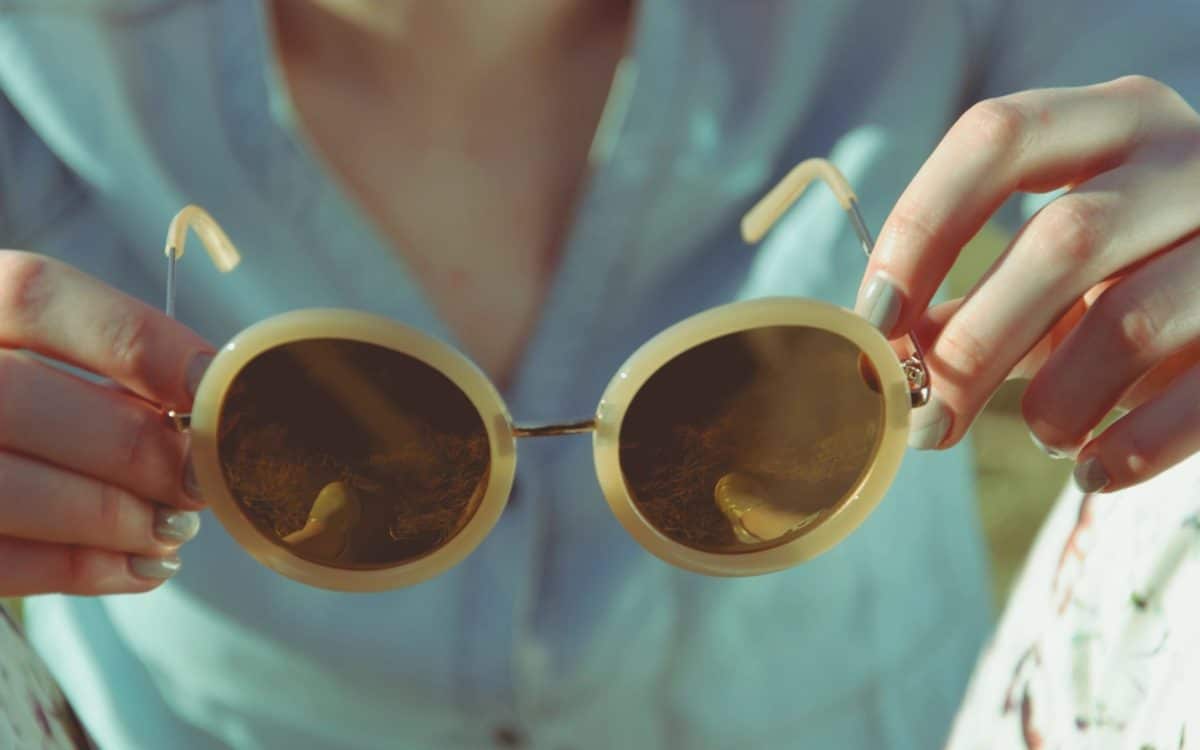 woman holding prescription sunglasses