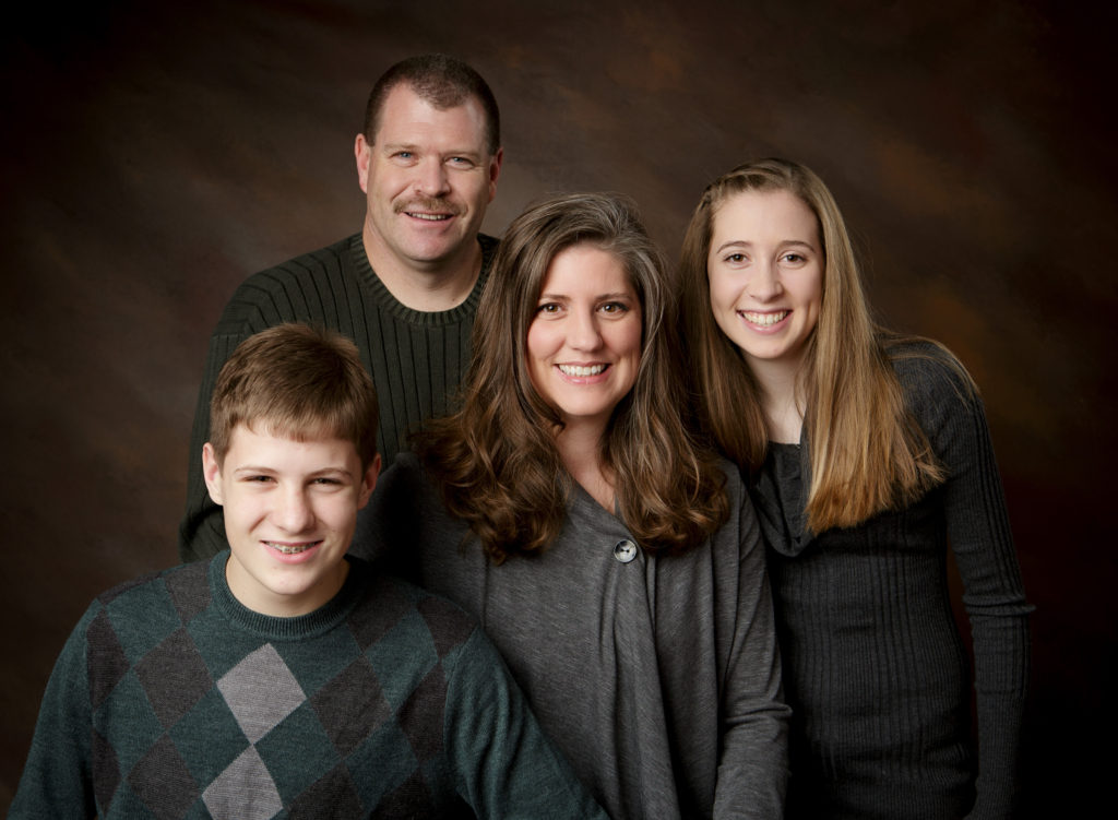 Dr. Franko posing for a family photo with husband and two children